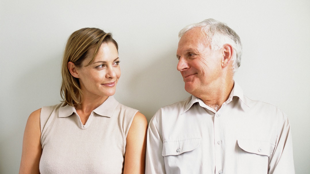 woman and older man smiling together
